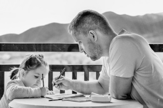 A man and child are sitting at the table